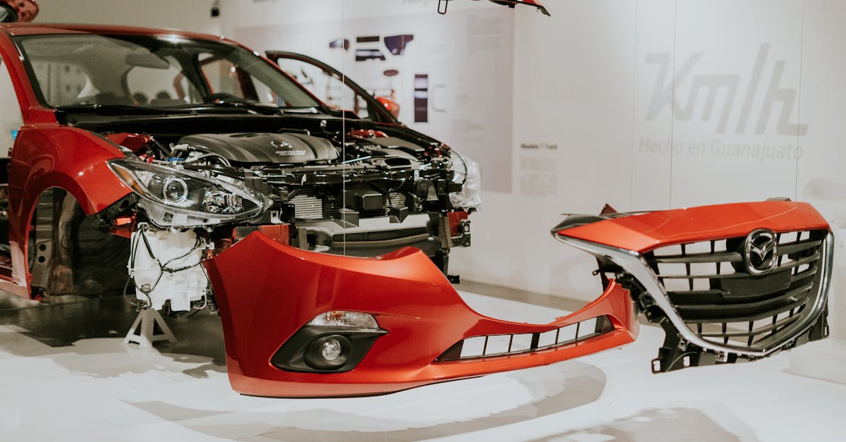 explore a detailed view of a partially disassembled red mazda 3 showcased at an auto exhibition